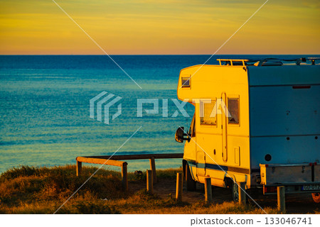 Camper vehicle on beach at sunrise 133046741