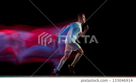 Soccer player sprinting with red and blue neon motion blur symbolizing speed and drive Soccer player sprinting with red and blue neon motion blur symbolizing speed and drive 133046914