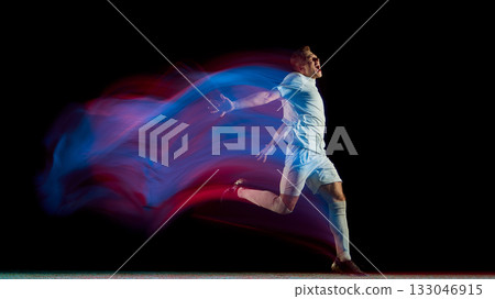 Soccer player running in neon light motion with expressive celebration gesture Soccer player running in neon light motion with expressive celebration gesture 133046915