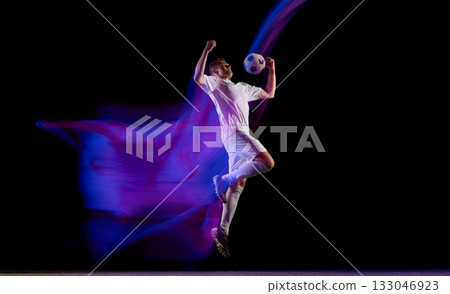 Soccer player heading ball in midair with light motion effect Soccer player heading ball in midair with light motion effect 133046923