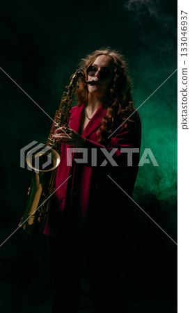 Saxophonist in maroon jacket performing on smoky stage with dramatic green light Saxophonist in maroon jacket performing on smoky stage with dramatic green light 133046937