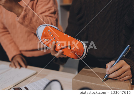 Asian woman describe selling clothes on camera live broadcast on social network at home, Online selling clothes on social media. Blogger woman influencer, SME retail store owner. 133047615