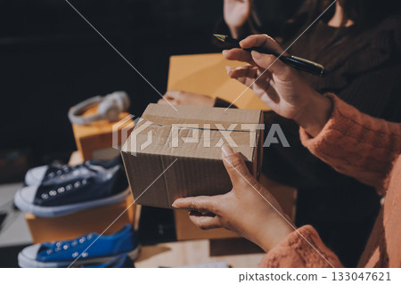 Asian woman describe selling clothes on camera live broadcast on social network at home, Online selling clothes on social media. Blogger woman influencer, SME retail store owner. 133047621