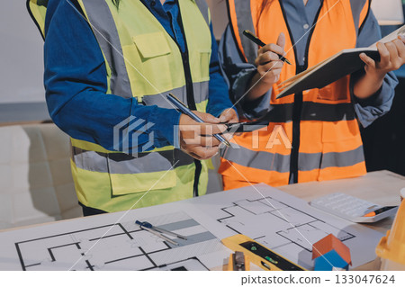 Architects and engineers working collaboratively on construction project Architects and engineers working collaboratively on construction project 133047624