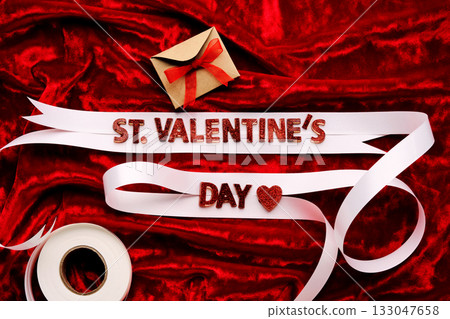 Festive background with the words St. Valentine's Day with red velvet and white ribbon. Festive background with the words St. Valentine's Day with red velvet and white ribbon. 133047658