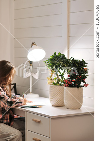 Girl drawing at desk, learning and studying at home Girl drawing at desk, learning and studying at home 133047665