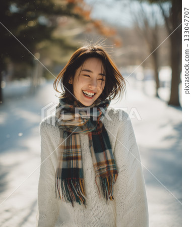 A woman smiling and having fun on a snowy winter day | A natural portrait full of natural charm 133047707