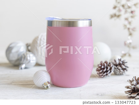 Mockup of Blank pink Stainless Steel wine tumbler near Christmas baubles on wooden table closeup Mockup of Blank pink Stainless Steel wine tumbler near Christmas baubles on wooden table closeup 133047723