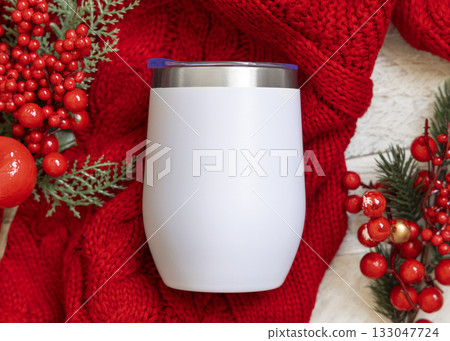White Stainless Steel wine tumbler on red knitted sweater near Christmas berries top view, mockup White Stainless Steel wine tumbler on red knitted sweater near Christmas berries top view, mockup 133047724