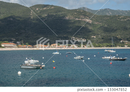 Spectacular view Golf at Sagone Corsica France beautyful sand Beach boats mountain village Tourism and vacations concept 133047852