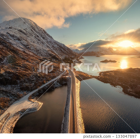 Aerial view of coastal road at winter sunset. Lofoten Islands Aerial view of coastal road at winter sunset. Lofoten Islands 133047897