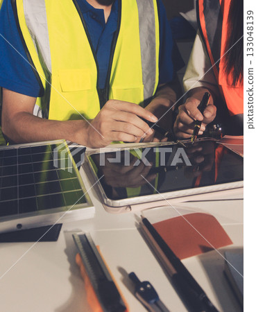Closeup of team of industrial engineers meeting analyze machinery blueprints consult project on table in manufacturing factory. Working in manufacturing plant or production plant. 133048139