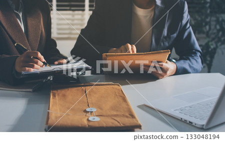 Lawyer explained to the client about the law that must be brought against the court case. Lawyer explained to the client about the law that must be brought against the court case. 133048194