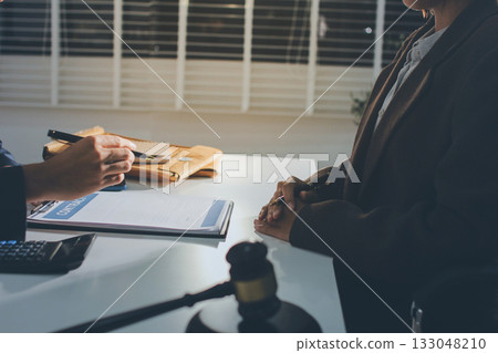 Lawyer explained to the client about the law that must be brought against the court case. Lawyer explained to the client about the law that must be brought against the court case. 133048210