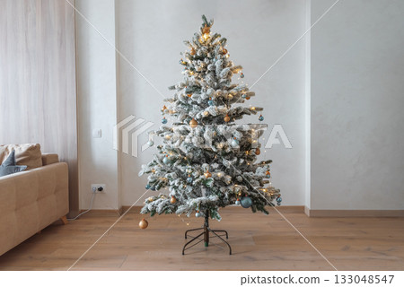 Cozy Living Room with Decorated Christmas Tree and Festive Interior Cozy Living Room with Decorated Christmas Tree and Festive Interior 133048547