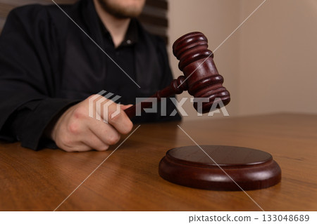 A judge is seen bringing down a gavel onto a sound block A judge is seen bringing down a gavel onto a sound block 133048689