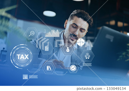 Professional man working on tax documents in an office with digital graphics overlay Professional man working on tax documents in an office with digital graphics overlay 133049134