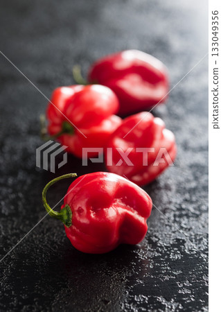 Red chili pepper habanero on black table. 133049356