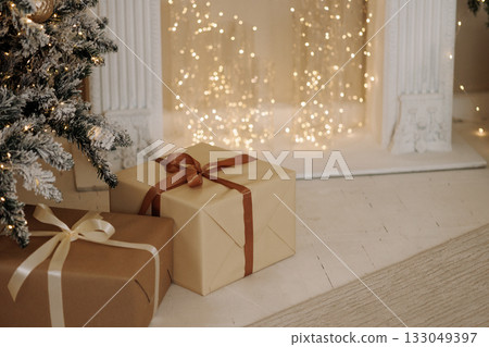 Christmas gifts under tree in cozy classic room with warm lights and white floor Christmas gifts under tree in cozy classic room with warm lights and white floor 133049397