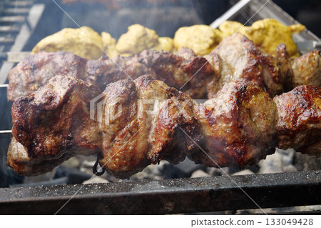 Burnt dry kebabs. Unhealthy food. Fat meat with carcinogens and bad cholesterol Burnt dry kebabs. Unhealthy food. Fat meat with carcinogens and bad cholesterol 133049428