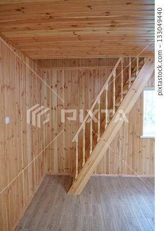 A new wooden staircase leading to the second floor of the house 133049440