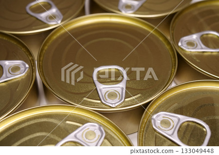 Yellow metal closed tin cans 133049448