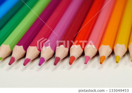 New wooden colored pencils of rainbow colors, perfectly sharpened, lie on table New wooden colored pencils of rainbow colors, perfectly sharpened, lie on table 133049453