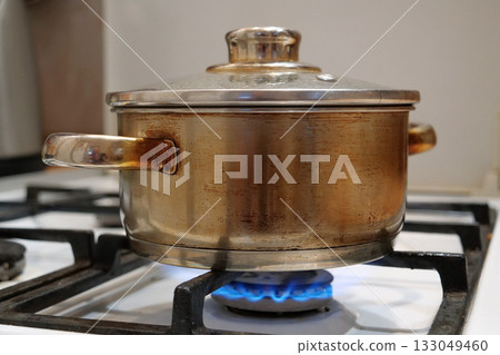 Cooking. The saucepan is on the gas stove. Meat is stewing 133049460
