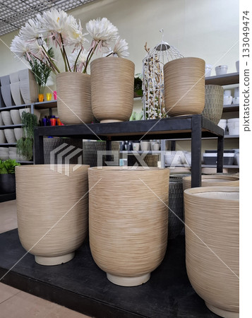 Large ceramic flower pots on supermarket shelves 133049474
