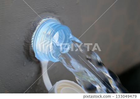 Water is leaking from the tank. Water drains from a frame pool. Draining water 133049479
