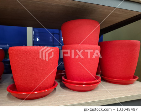Flower pots are sold at flower shop.Red ceramic flower pots on supermarket shelf Flower pots are sold at flower shop.Red ceramic flower pots on supermarket shelf 133049487