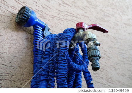 Outdoor tap for watering a garden plot. Water tap outside the building Outdoor tap for watering a garden plot. Water tap outside the building 133049499