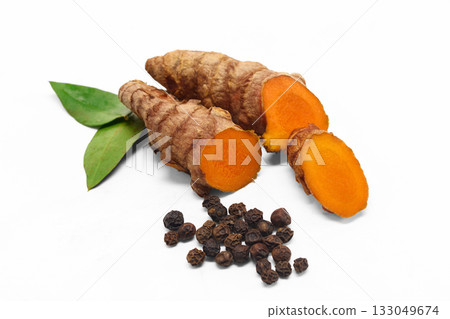 Turmeric and Pepper. Fresh turmeric, sliced piece, black peppercorns 133049674