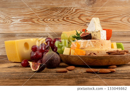 Cheese plate of color cheeses variety, yellow, white and blue cheese board, assorted dairy products Cheese plate of color cheeses variety, yellow, white and blue cheese board, assorted dairy products 133049862