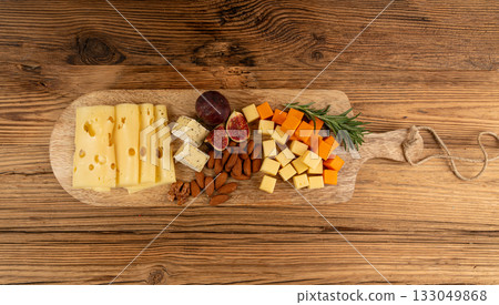 Cheese plate of color cheeses variety, yellow, white and blue cheese board, assorted dairy products Cheese plate of color cheeses variety, yellow, white and blue cheese board, assorted dairy products 133049868