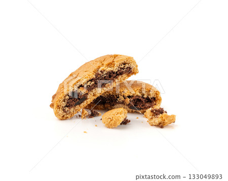 Crumbled chocolate cookies with chocolate filling isolated, brown round biscuits pieces 133049893