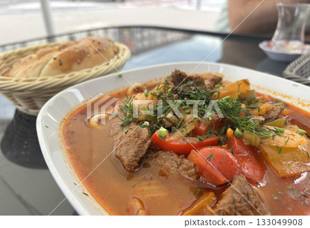 Chorba lamb soup, shurpa in Arabic restaurant. Kazakh meal with meat, spices and vegetables 133049908