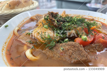 Chorba lamb soup, shurpa in Arabic restaurant. Kazakh meal with meat, spices and vegetables 133049909