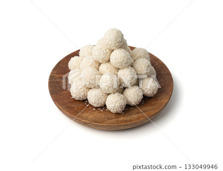 Coconut candies pile, coco ball. White truffle ball, indian ladoo or laddu with sweet cream 133049946