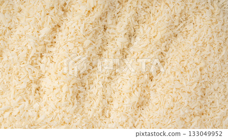Grated coconut powder. Dry coco flakes pile, shredded desiccated coconut, tropical fruit chips 133049952