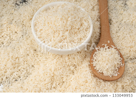 Grated coconut powder. Dry coco flakes pile, shredded desiccated coconut, tropical fruit chips 133049953