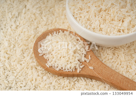 Grated coconut powder. Dry coco flakes pile, shredded desiccated coconut, tropical fruit chips 133049954