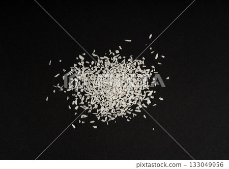 Grated coconut powder. Dry coco flakes pile, shredded desiccated coconut, tropical fruit chips Grated coconut powder. Dry coco flakes pile, shredded desiccated coconut, tropical fruit chips 133049956