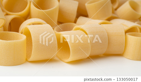 Raw Calamarata Big Pasta Isolated, Homemade Dry Macaroni, Italian Raw Round Noodle Raw Calamarata Big Pasta Isolated, Homemade Dry Macaroni, Italian Raw Round Noodle 133050017