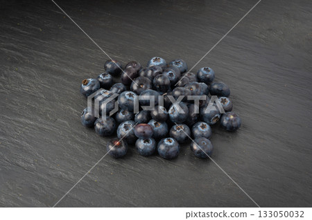 Blueberry on black plate. Fresh blue berry fruits, bilberry group on dark background 133050032