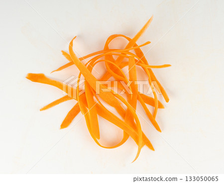 Thin carrot strips isolated. Carrot slices for vegetable salad Thin carrot strips isolated. Carrot slices for vegetable salad 133050065