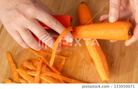 Fresh Carrot Peeling with Knife Close Up, Raw Carrot Slices, Orange Root Vegetable Fresh Carrot Peeling with Knife Close Up, Raw Carrot Slices, Orange Root Vegetable 133050071