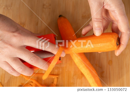Fresh Carrot Peeling with Knife Close Up, Raw Carrot Slices, Orange Root Vegetable 133050072
