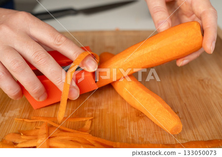 Fresh Carrot Peeling with Knife Close Up, Raw Carrot Slices, Orange Root Vegetable 133050073