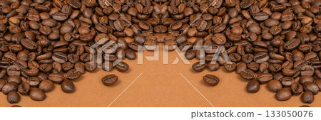 Dark brown whole coffee beans on wood background with copyspace Dark brown whole coffee beans on wood background with copyspace 133050076